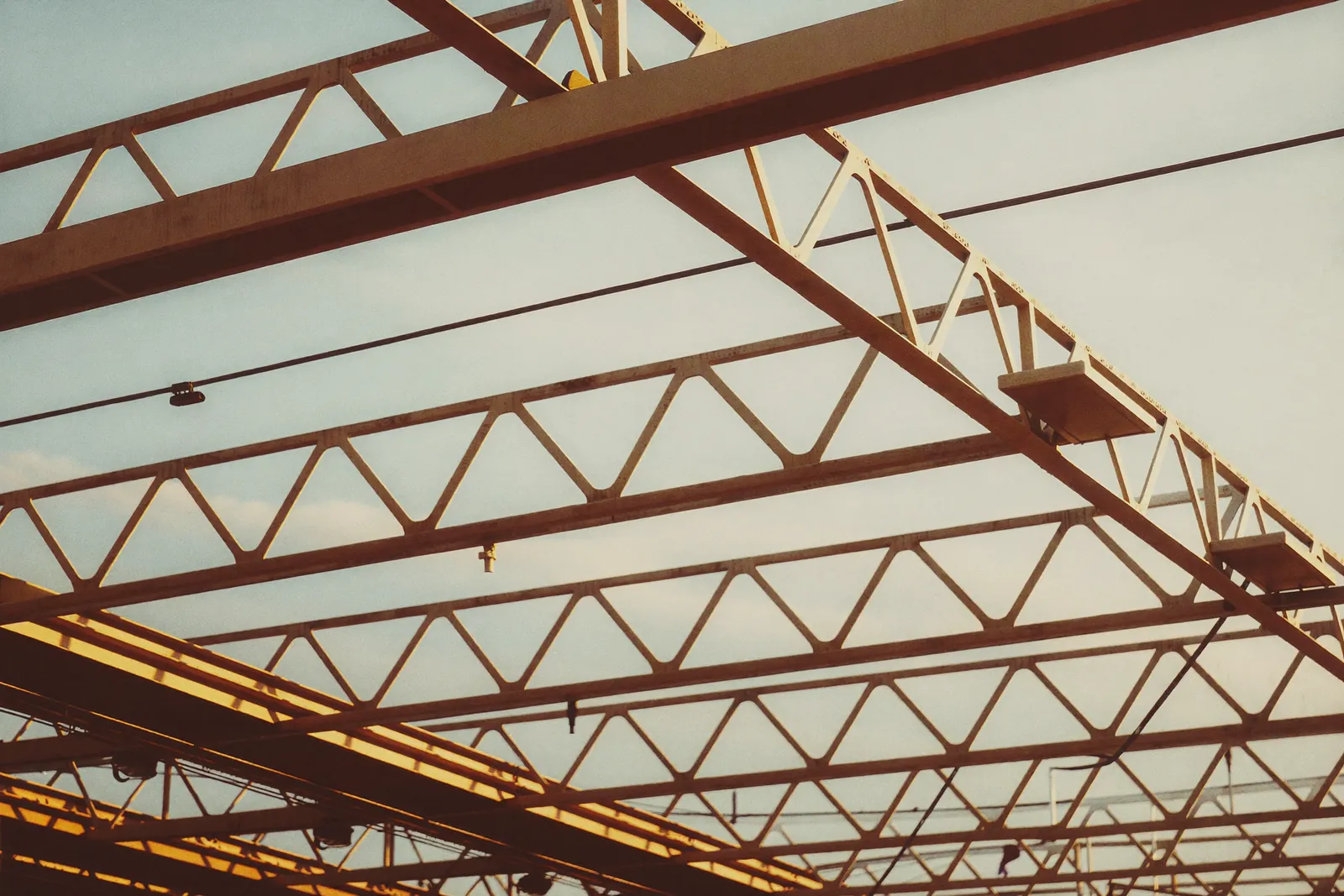 Steel roof trusses against the sky